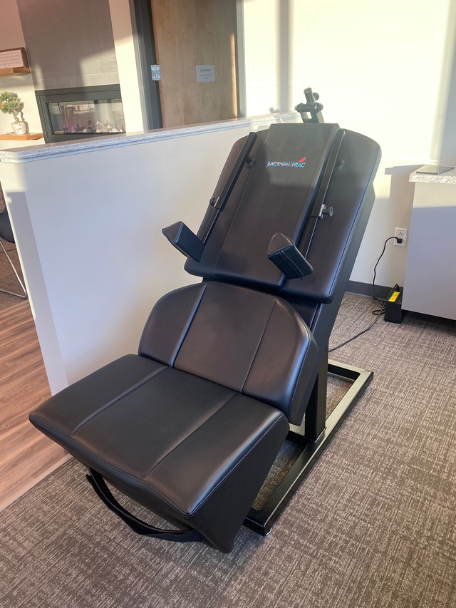 Back-on-Trac spinal decompression table in a chiropractic clinic treatment area.