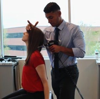 Dr. Eniel Rolon treating a patients sore neck.