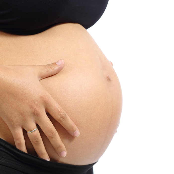 Side view of a pregnant woman's stomach.